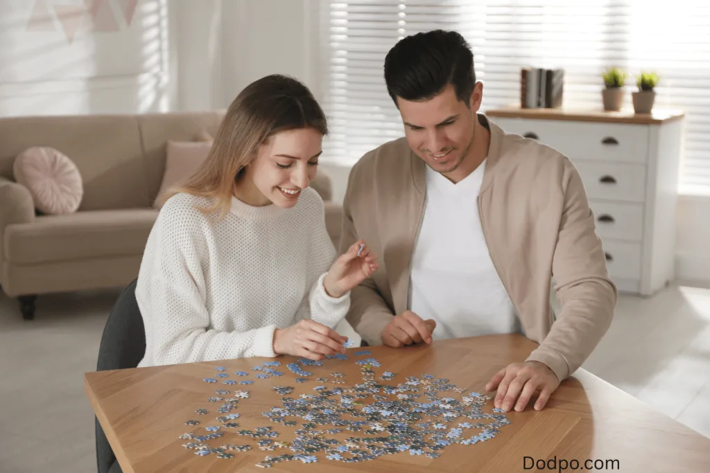 Couple in a date at home solving puzzle