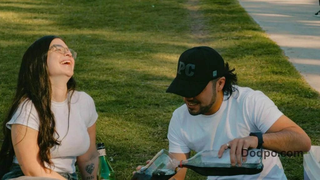 the second 3 - couple having a drink in a park
