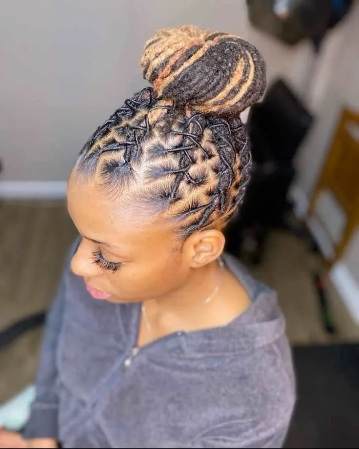 A corporate woman with medium-length brown locs styled into a sleek, polished high bun, ideal for boardroom meetings.