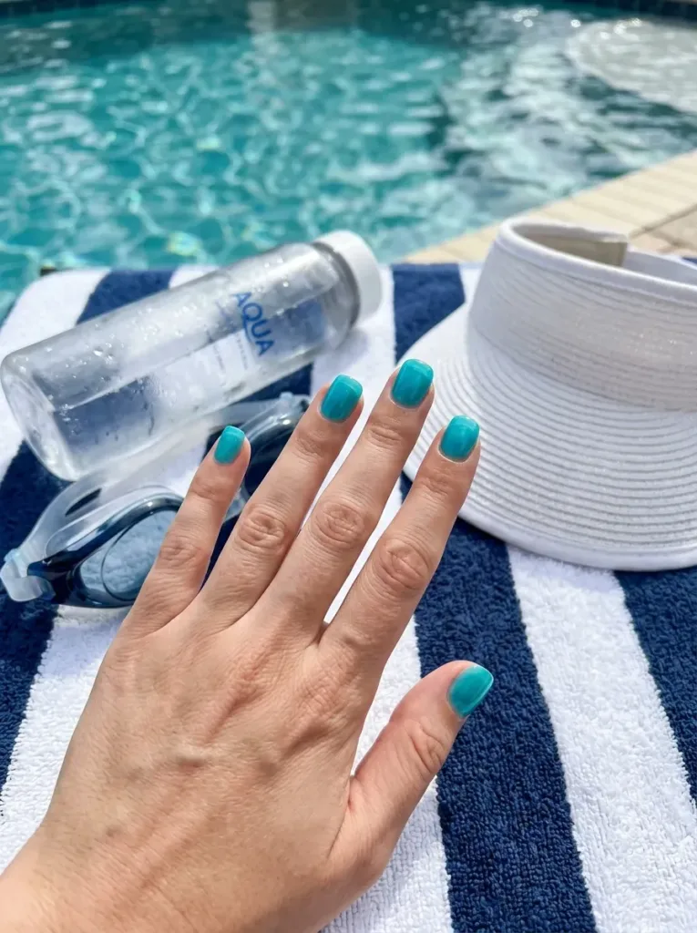 Short squoval nails layered with translucent aqua blue jelly polish