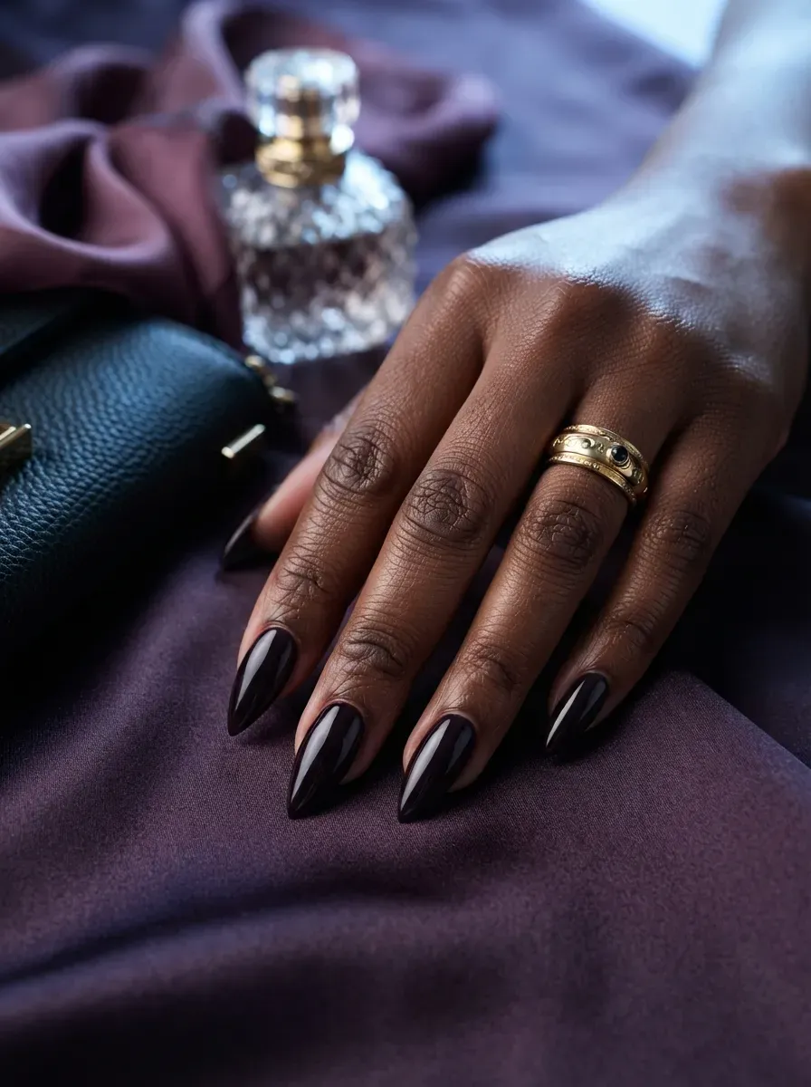 Aubergine deep French tips on stiletto nails with chestnut skin