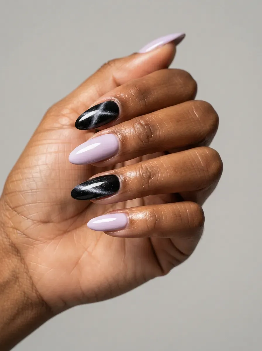 Long almond nails with black cat eye accents and pastel polish