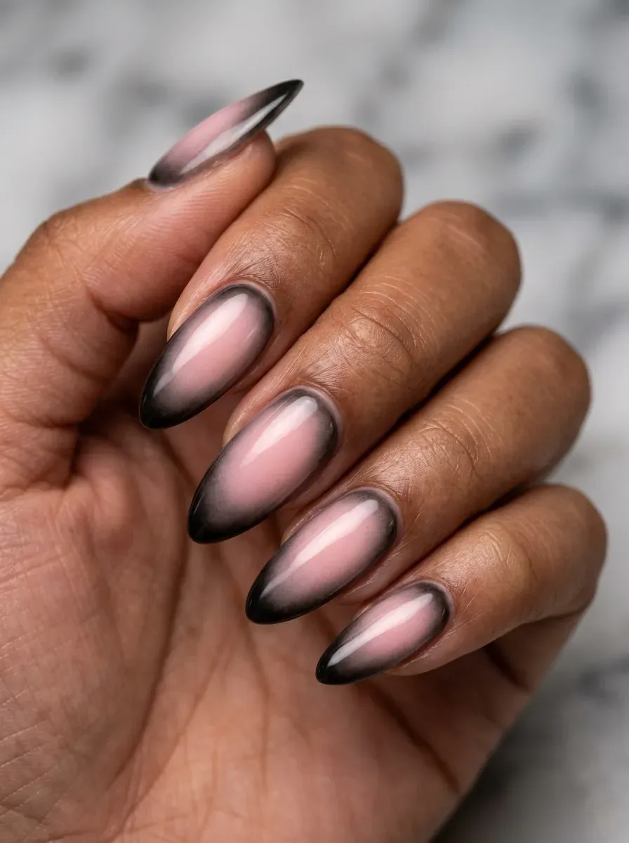 Long almond nails with soft pink and black aura centers