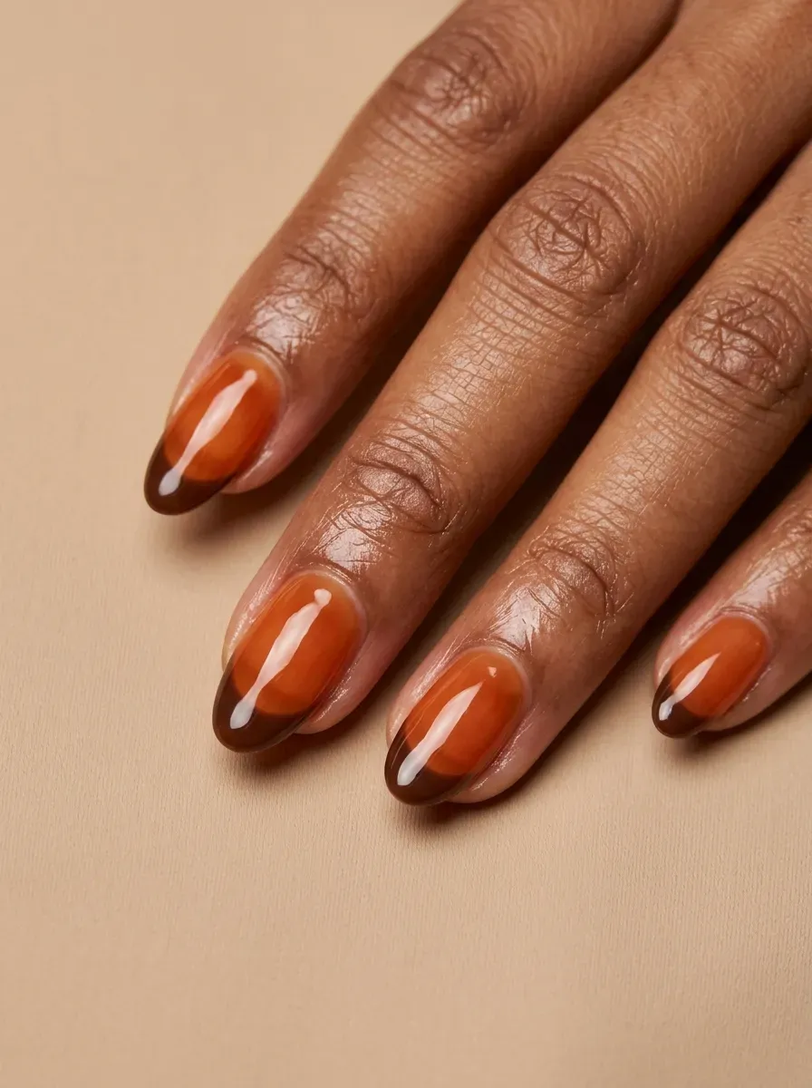 Medium oval nails with translucent burnt orange gel and chocolate tips