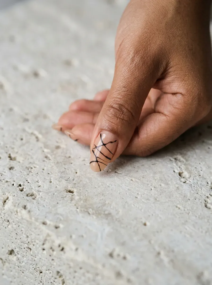 Thin line art nail design resembling jointed doll segments