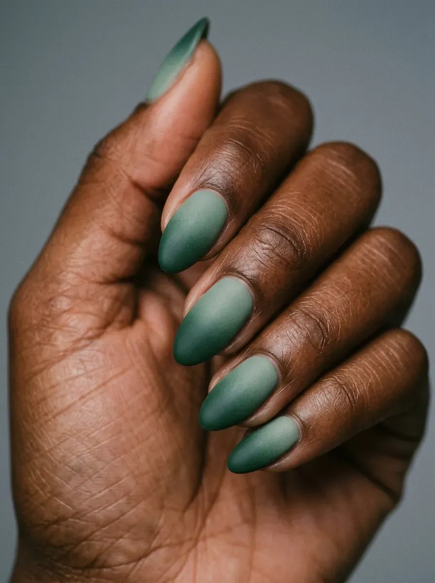 Ombre nails fading from sage green into deep forest green