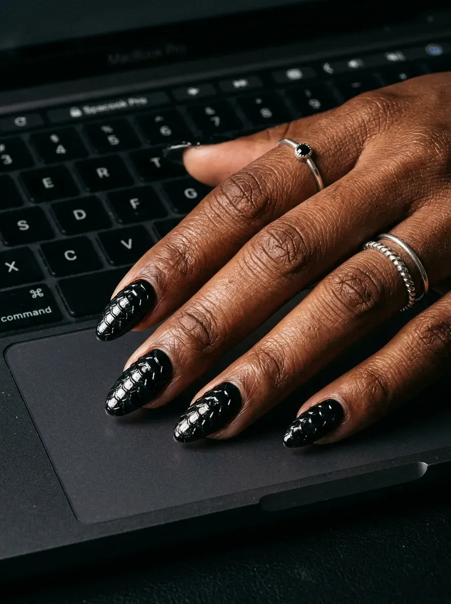 Glossy black nails textured with raised 3D reptile scale builder gel