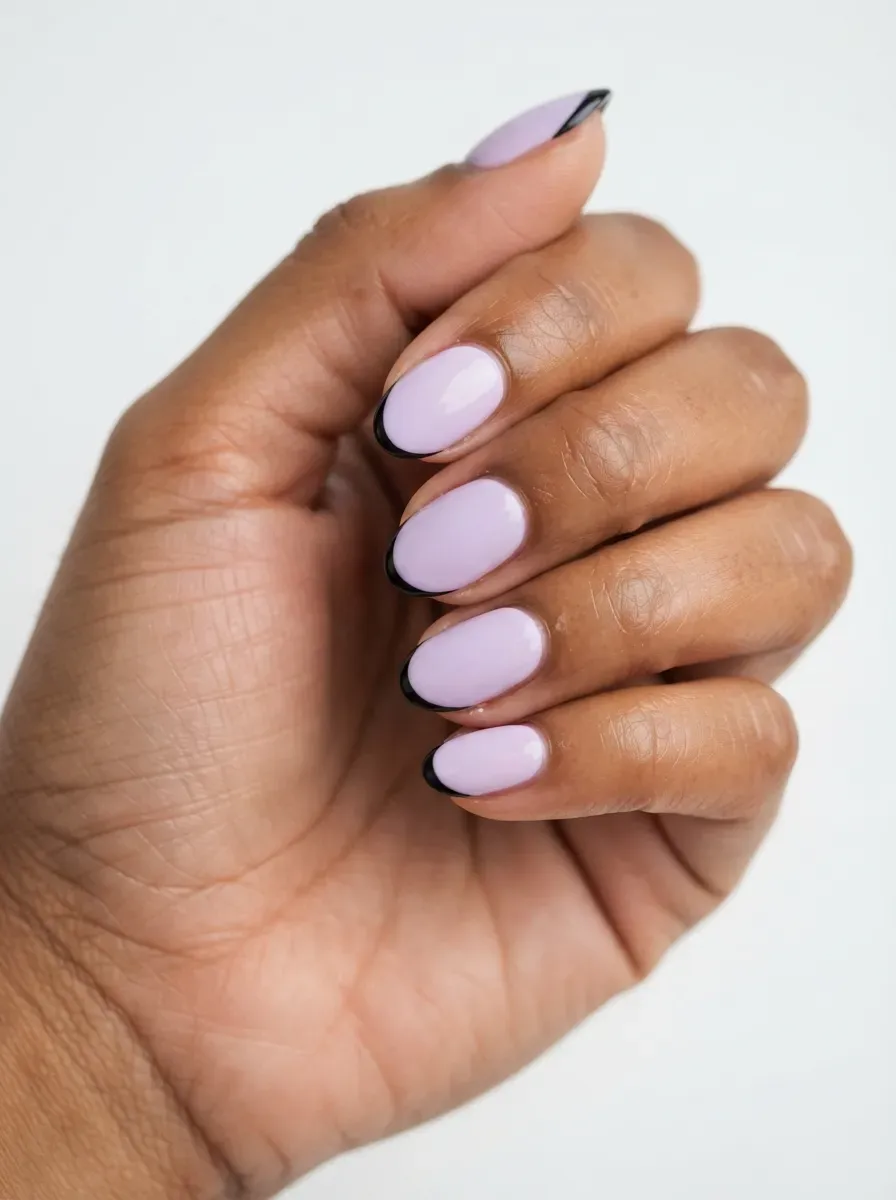 Lavender nails with thin black French tips on warm brown skin