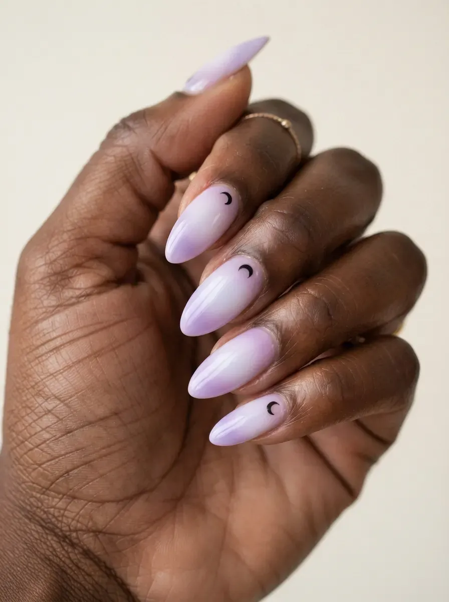 Lilac aura nails with black crescent moon accents and glossy finish