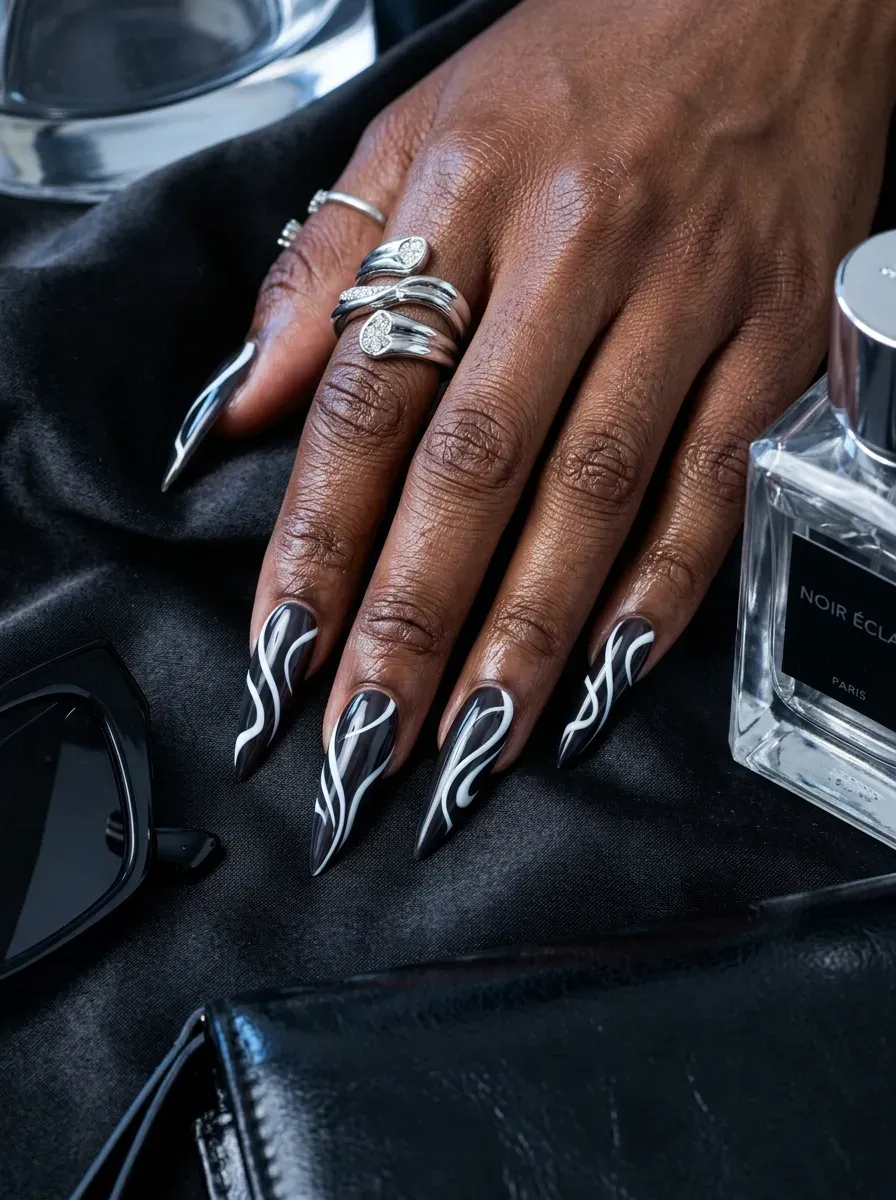 Long stiletto nails with dramatic white French tips on rich dark skin