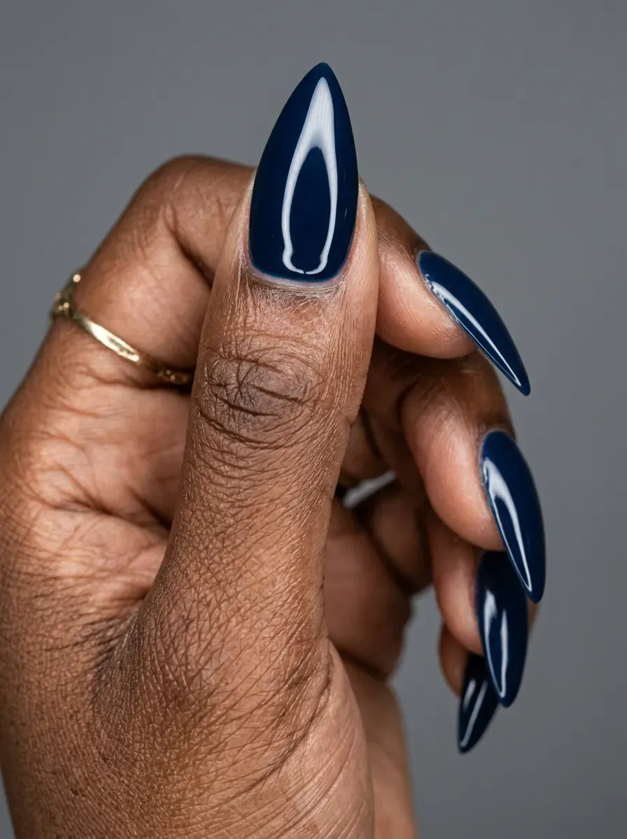 High-shine glazed navy nails with glossy donut-style finish