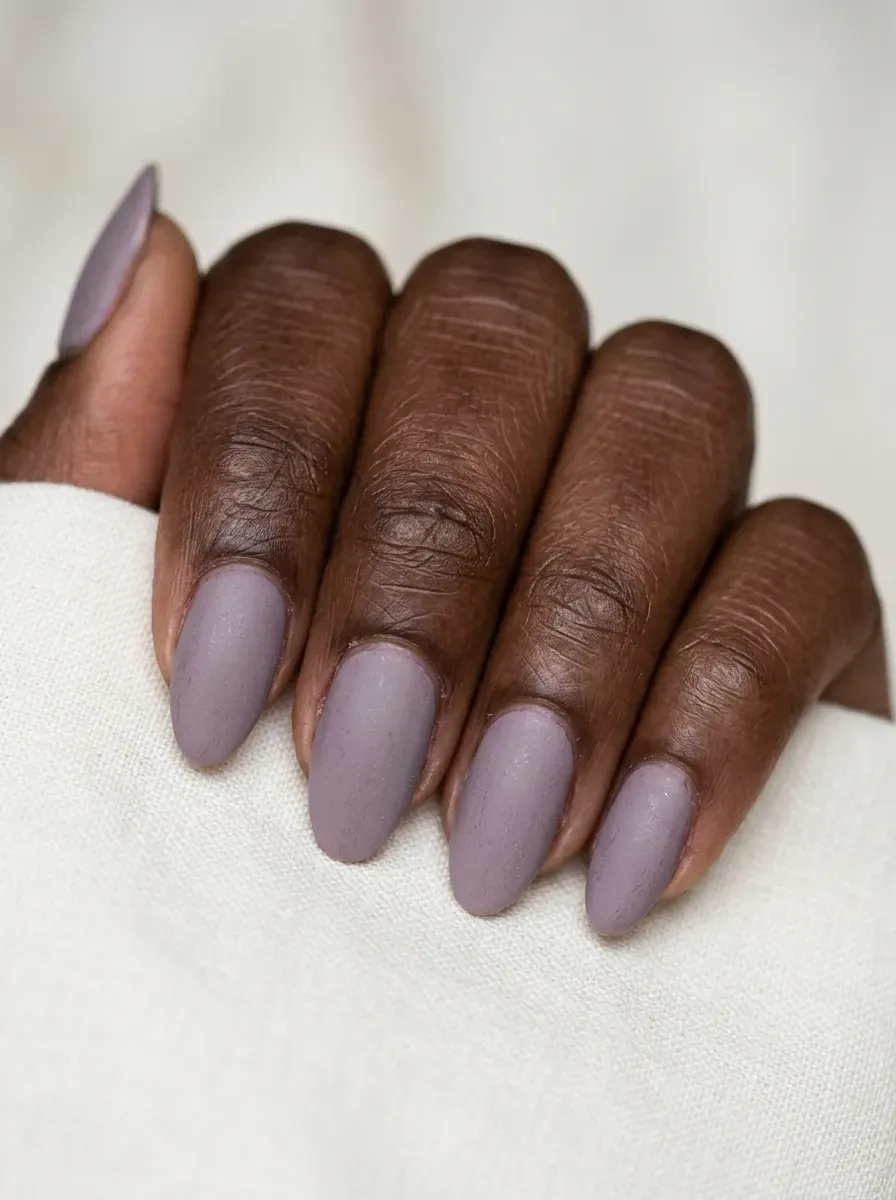Soft, muted lavender nails with a matte gothic finish