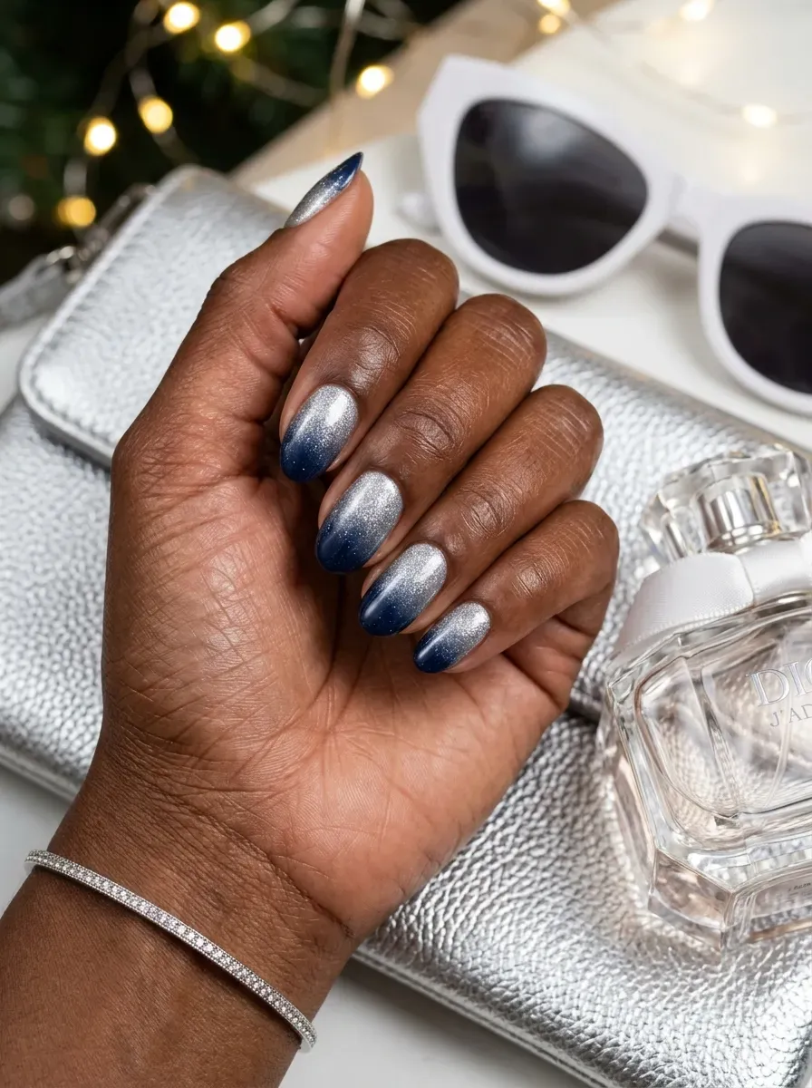 Navy nails fading into silver shimmer on deep chestnut skin