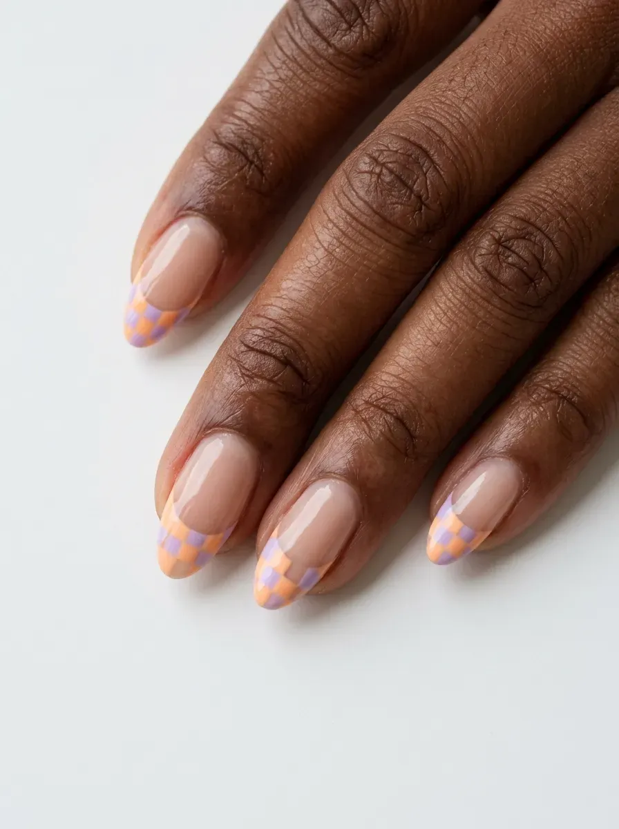 Medium almond nails with orange and lilac checkerboard French tips