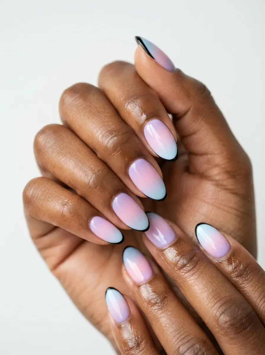 Pastel ombre nails with thin black French edges on brown skin and glossy finish