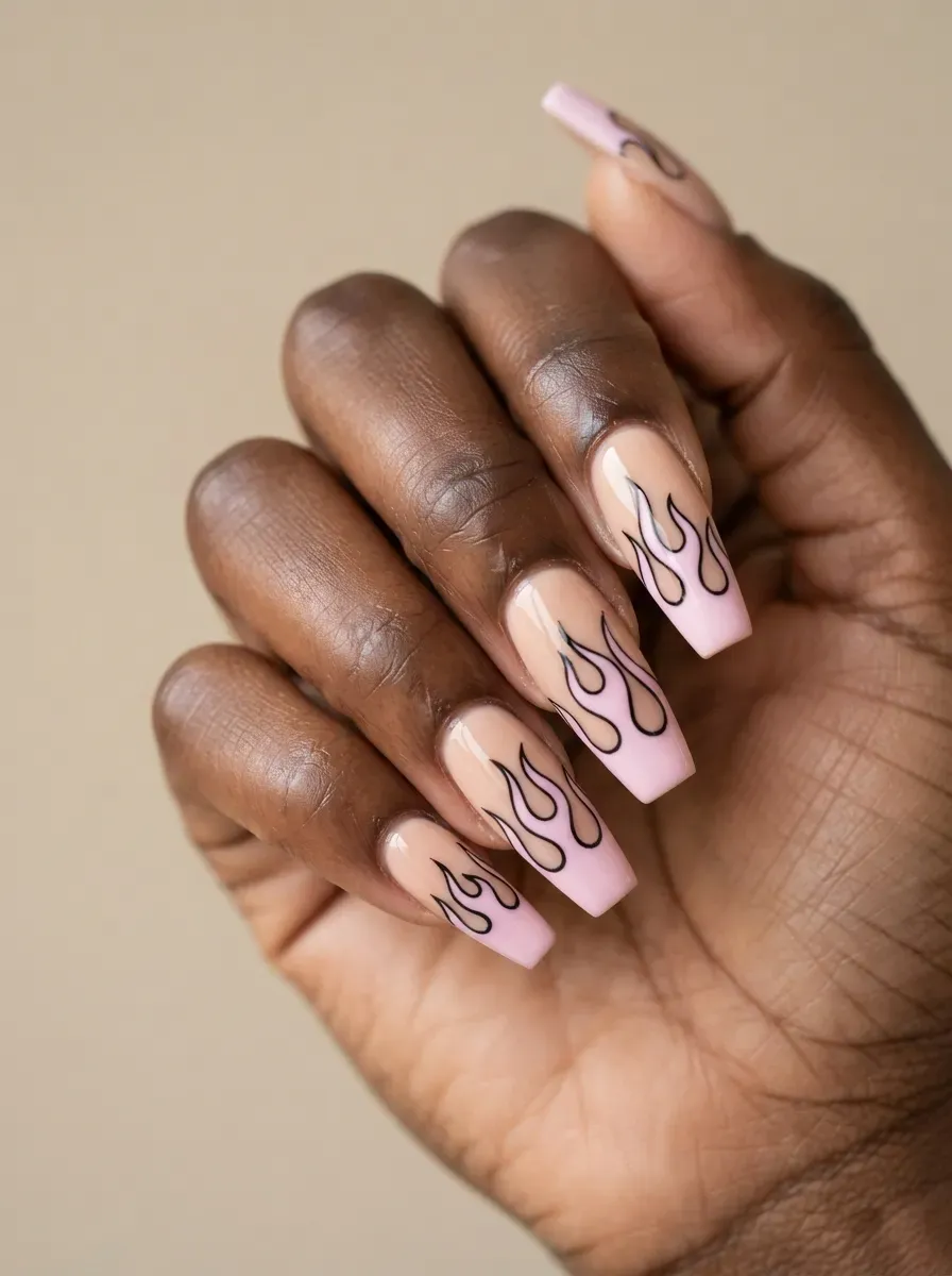 Pastel pink flame nails with thin black outlines on rich dark skin