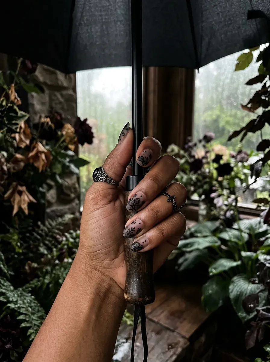 Translucent black tint nails featuring flat matte black floral lace art