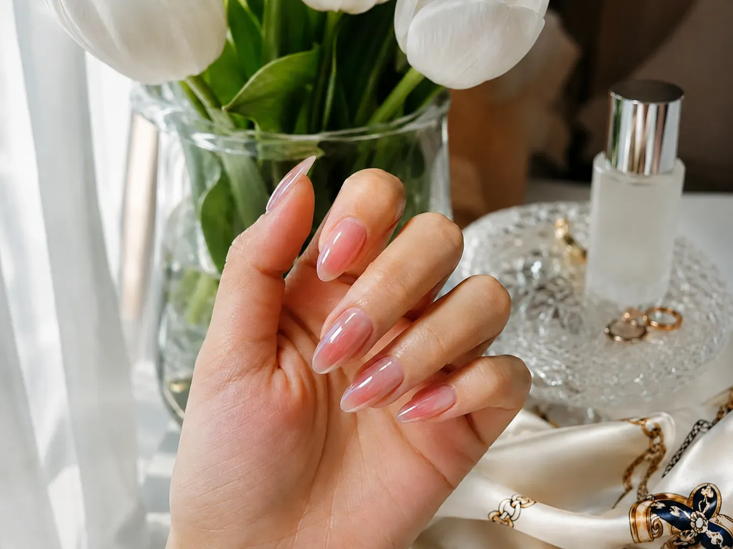 Long coffin nails with sheer pink color and transparent glassy shine