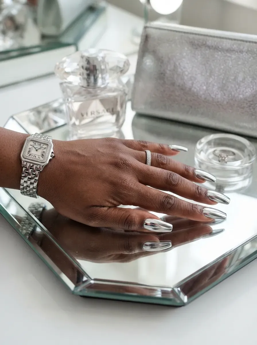 Silver chrome deep French tips on coffin nails over deep brown skin