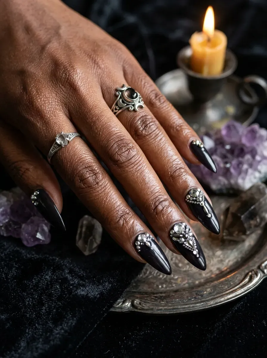 Crystal gem accents on dark witch inspired nails