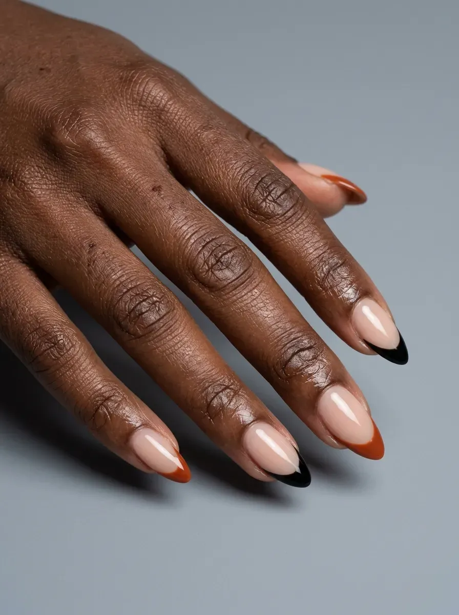Black and burnt orange French tips on almond shaped nails
