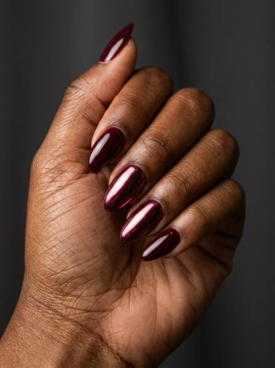 Burgundy chrome accent nails paired with deep red glossy polish
