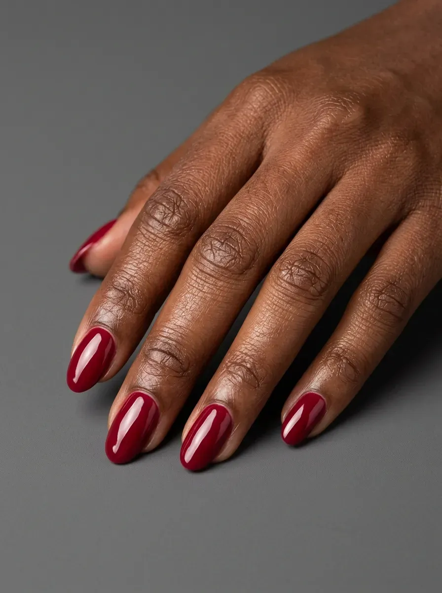 Glossy cranberry red nails with rich autumn inspired color