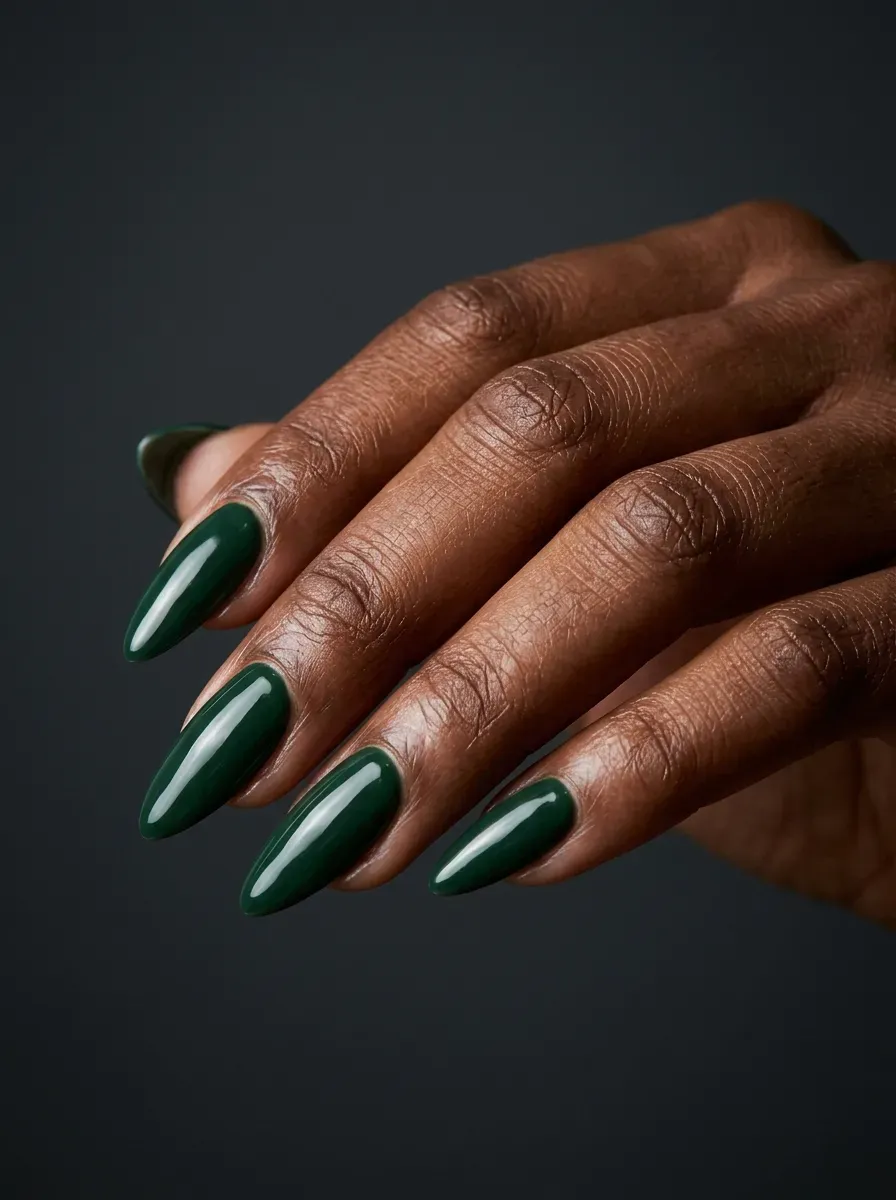 Deep forest green nails with glossy finish on deep brown skin