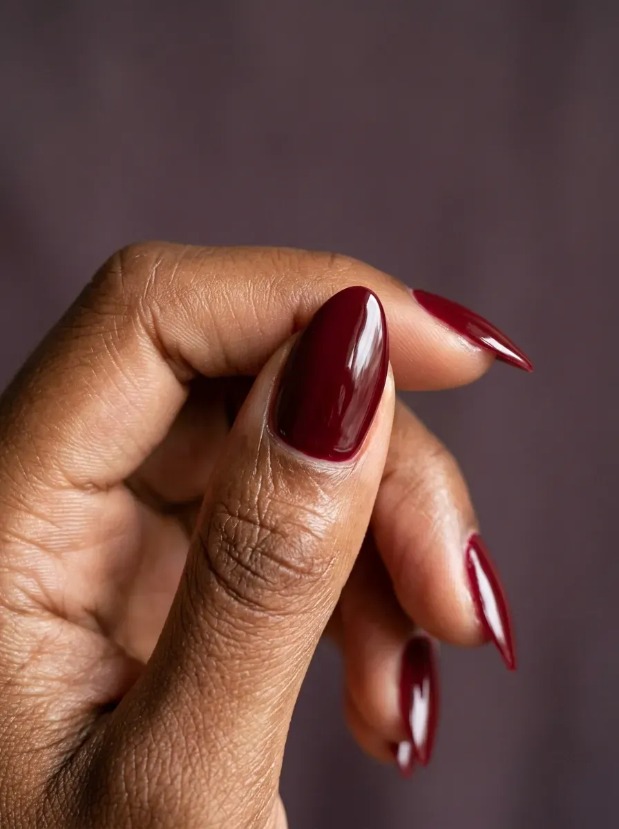 Deep merlot nails with high gloss finish on deep chestnut skin