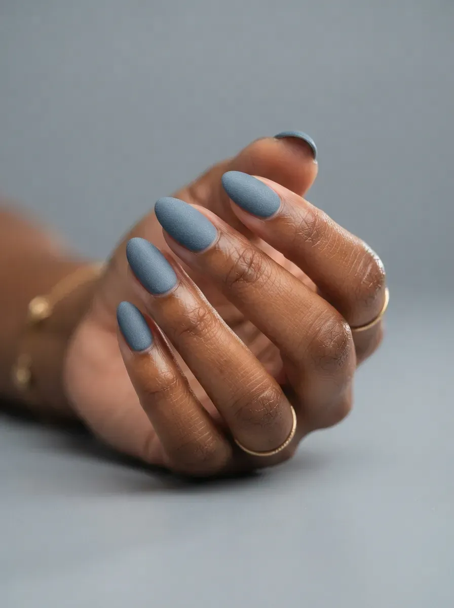 Muted denim blue gel nail polish in close-up