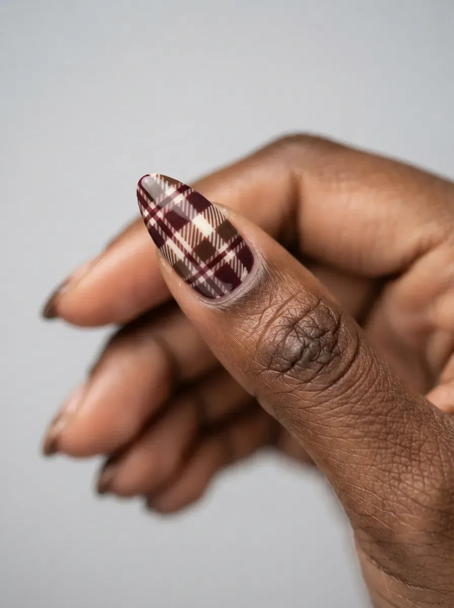 Small plaid pattern nail art detail in warm autumn tones