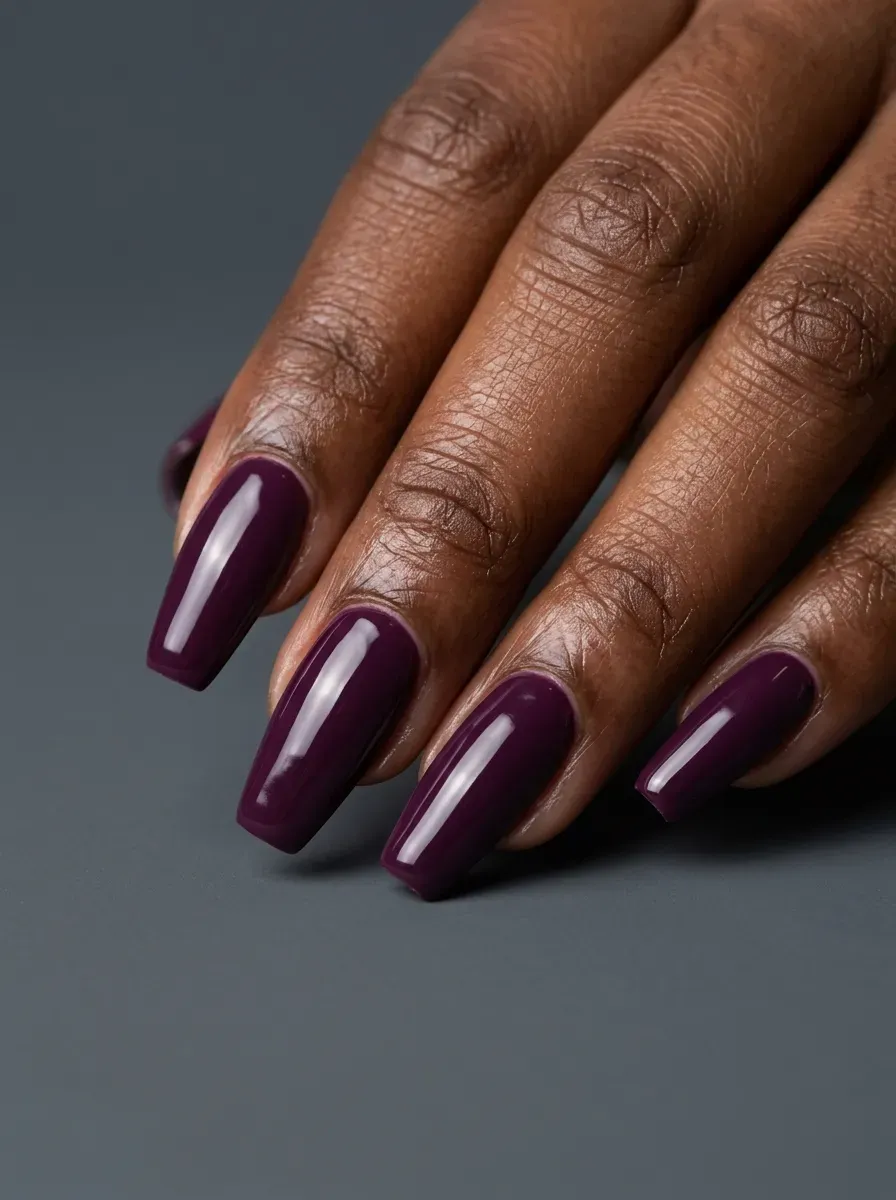 Rust orange French tips on short almond nails with glossy nude base