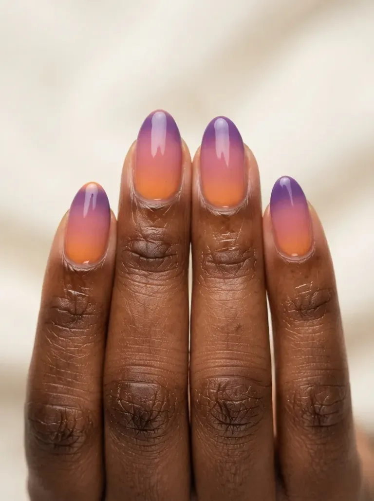 Ombre gel nails blending orange, pink, and purple sunset tones