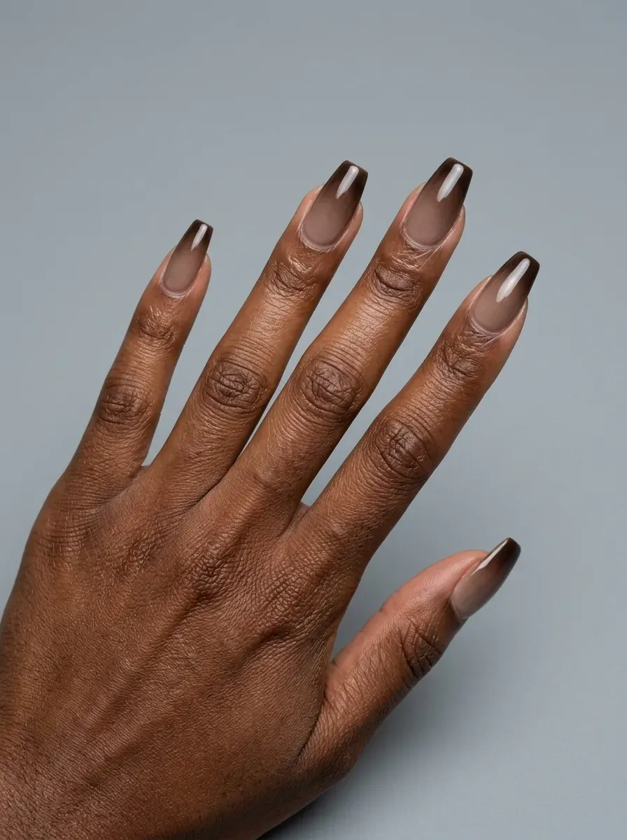 Smoky brown gradient nails transitioning through soft neutral shades