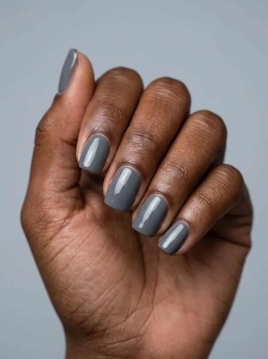 Smoky gray gel nails with glossy finish on deep brown skin