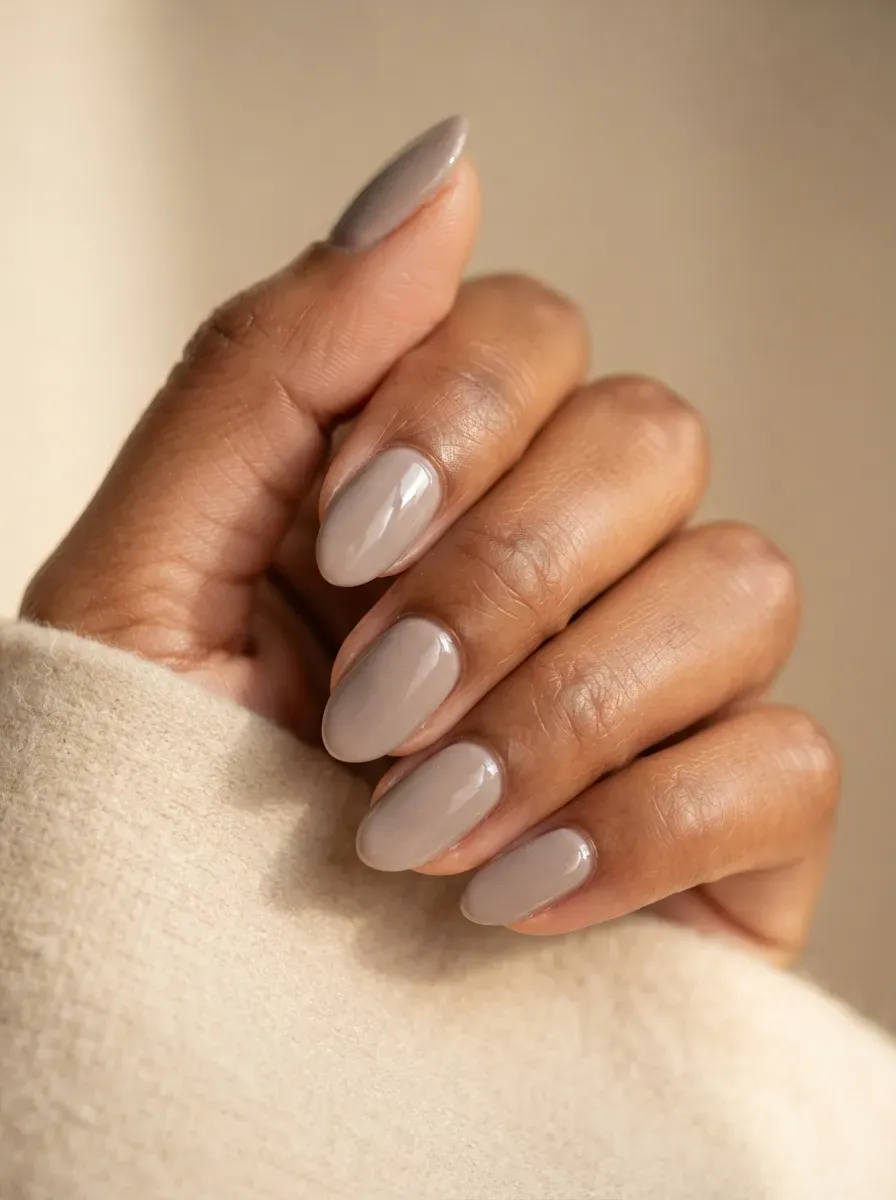 Neutral soft taupe gel nail polish shown in close-up