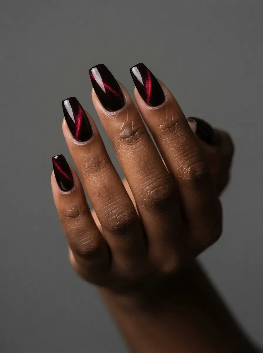 Black cherry nails with deep red magnetic cat-eye reflections