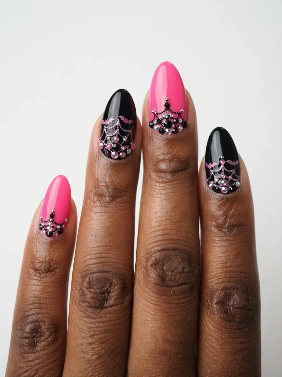 Close-up of black coffin nails with pink rhinestones at cuticles