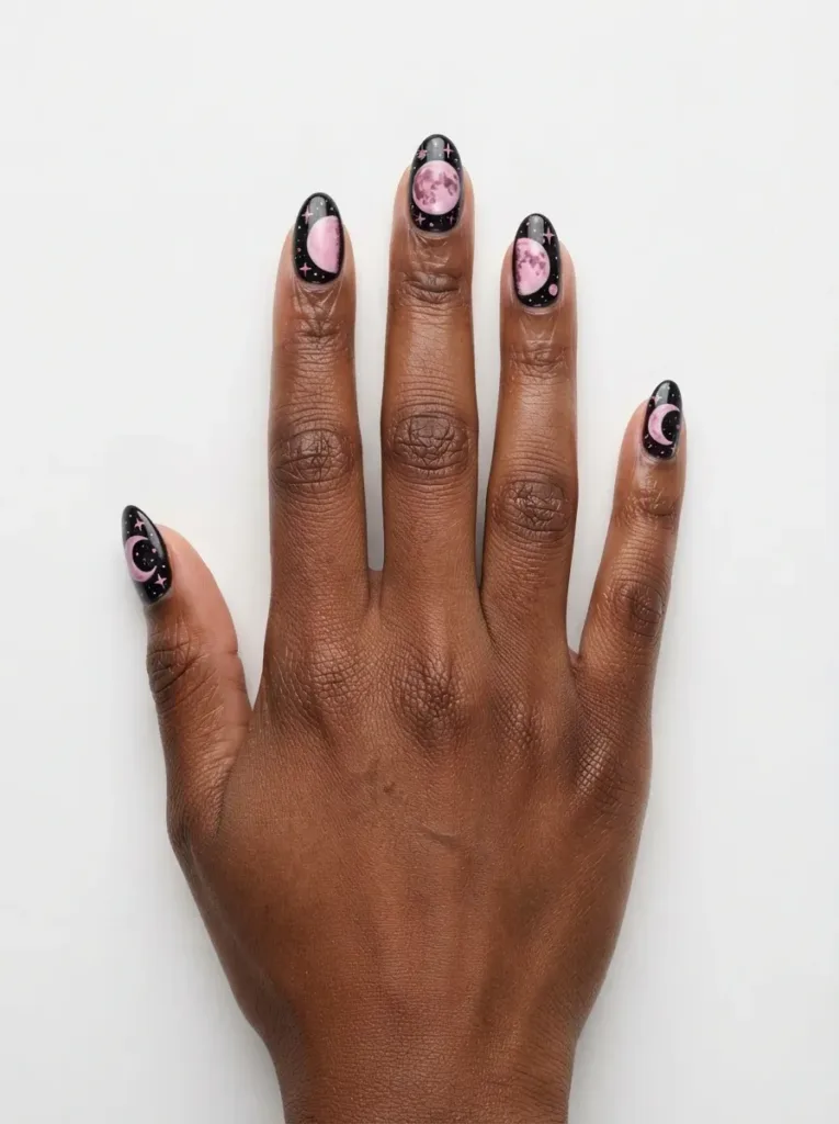 Close-up of nails with black and pink lightning bolt designs