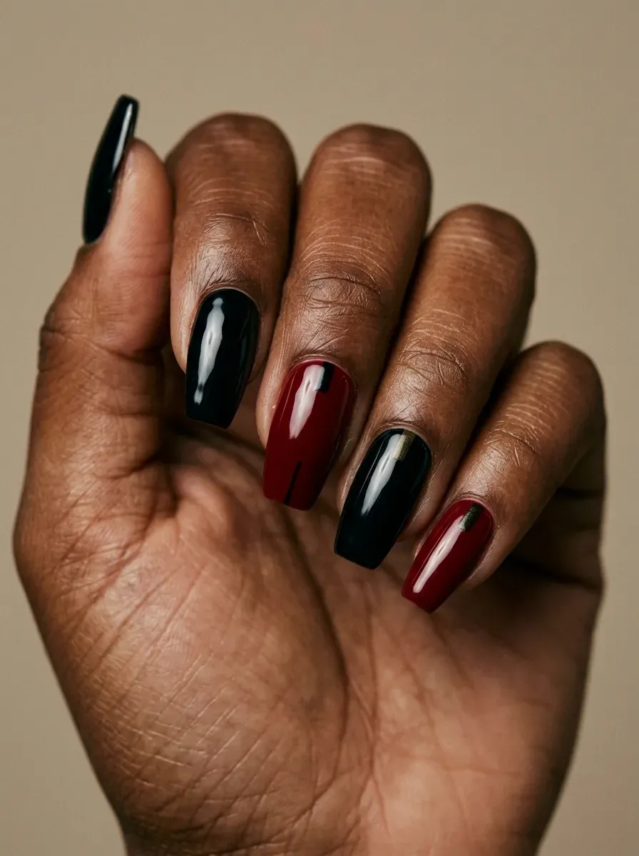 Glossy black and crimson nails with bold graphic horror manicure details