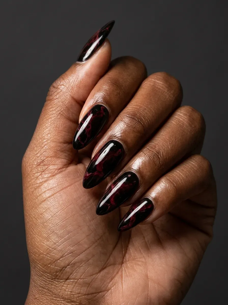 Black and crimson marble nails with glossy swirling horror-inspired finish