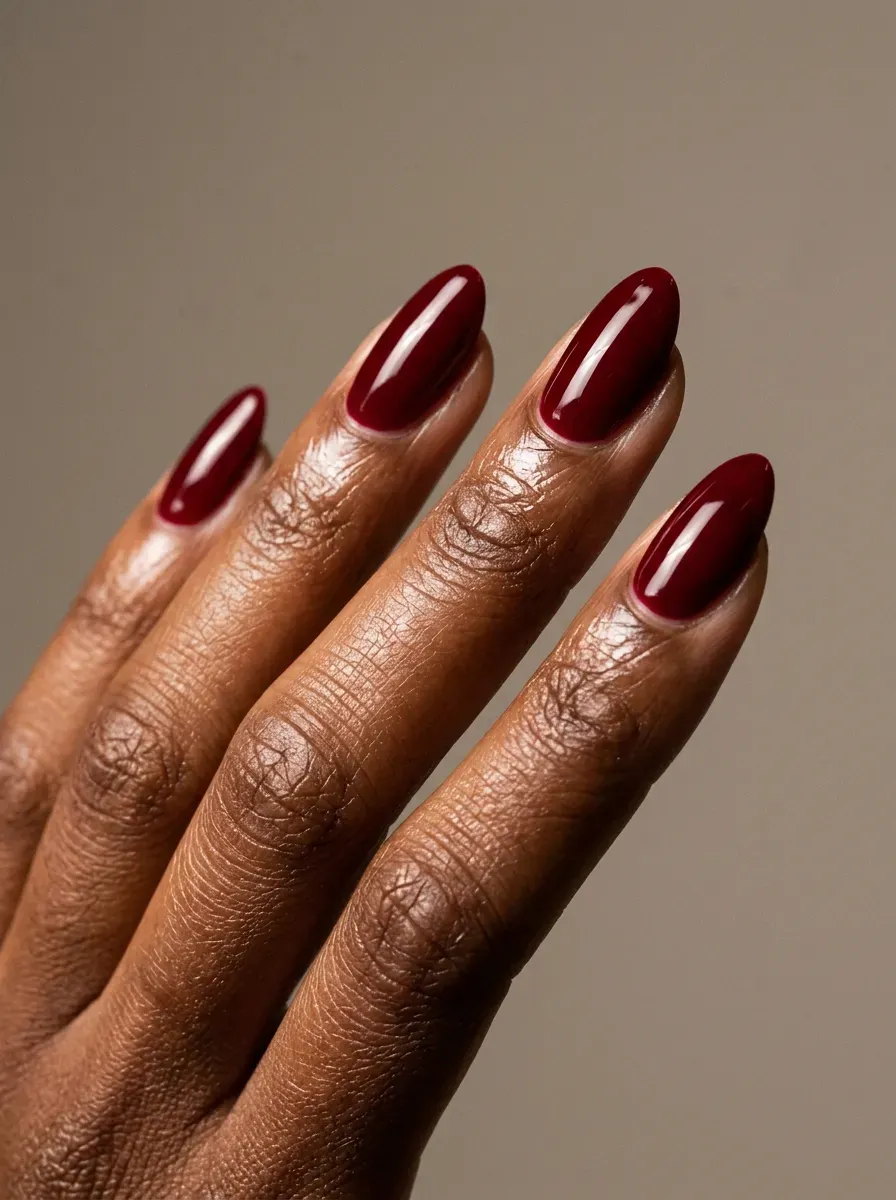 Deep cherry red almond nails with high-gloss dramatic Halloween finish