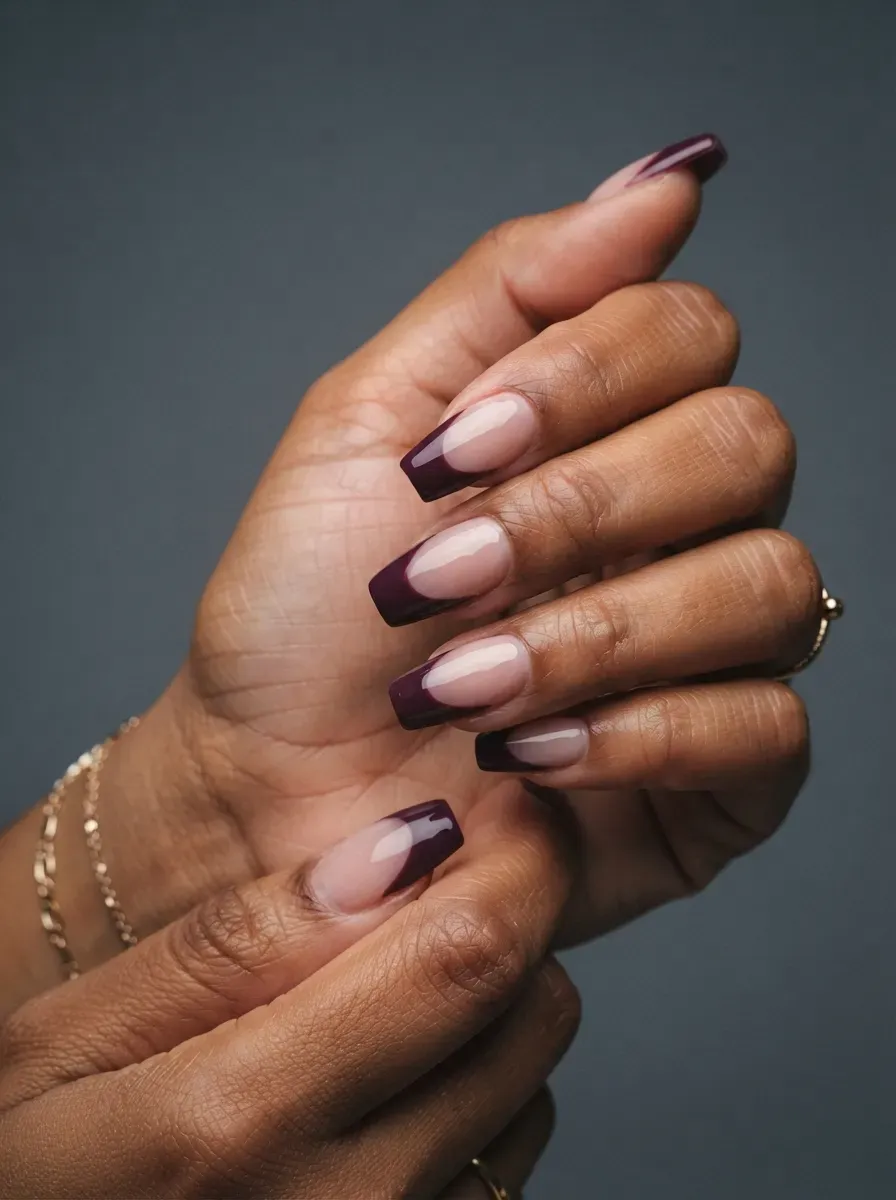 Medium coffin nails with deep plum French tips over sheer pink bases