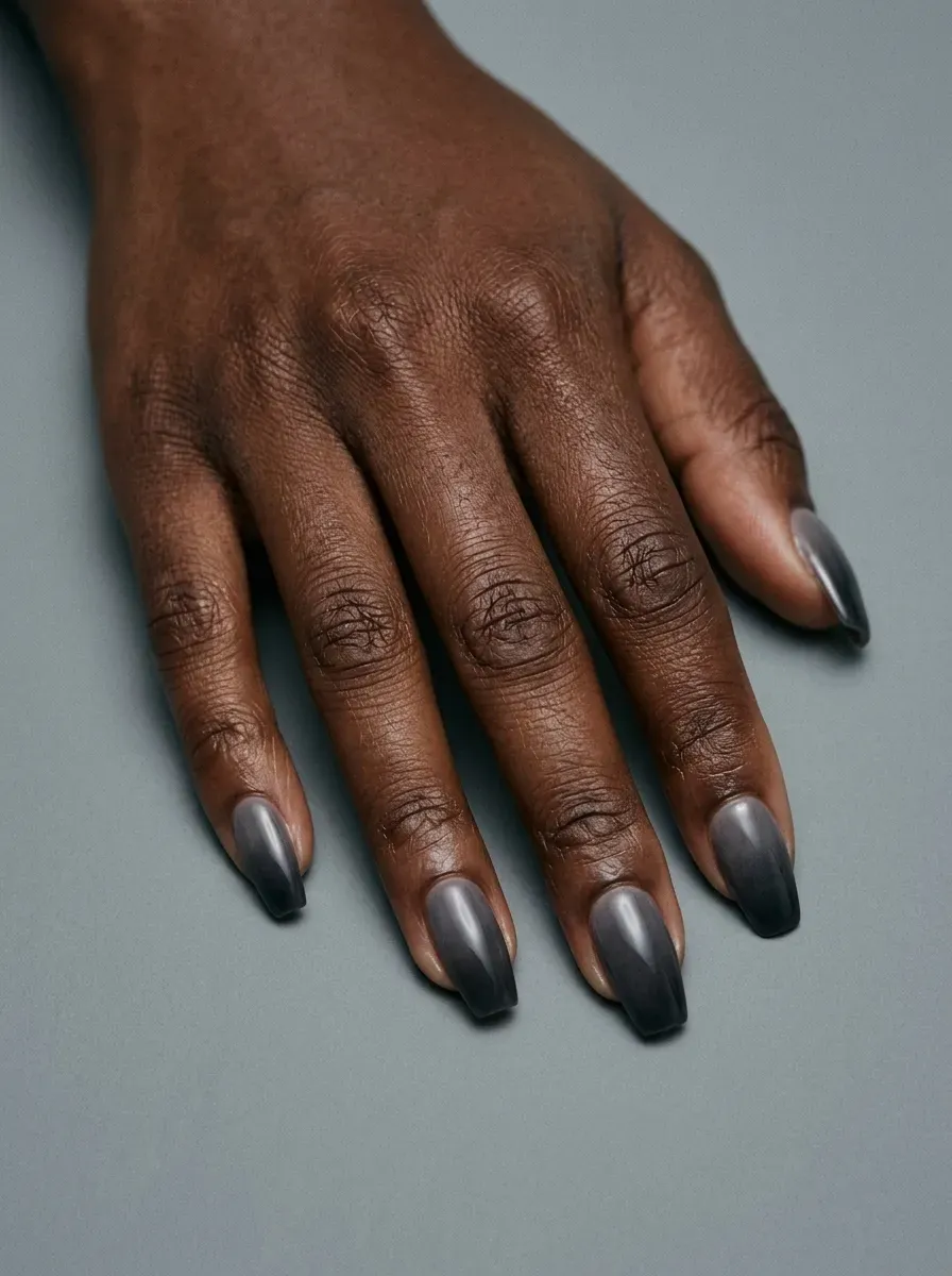 Smoky gray ombre nails with soft black tips and glossy Halloween finish