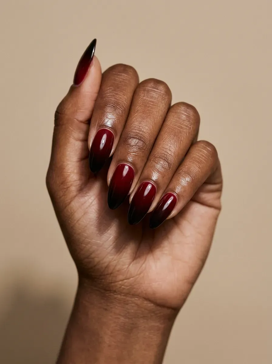 Black nails with tiny white eerie eyes painted across glossy dark manicure
