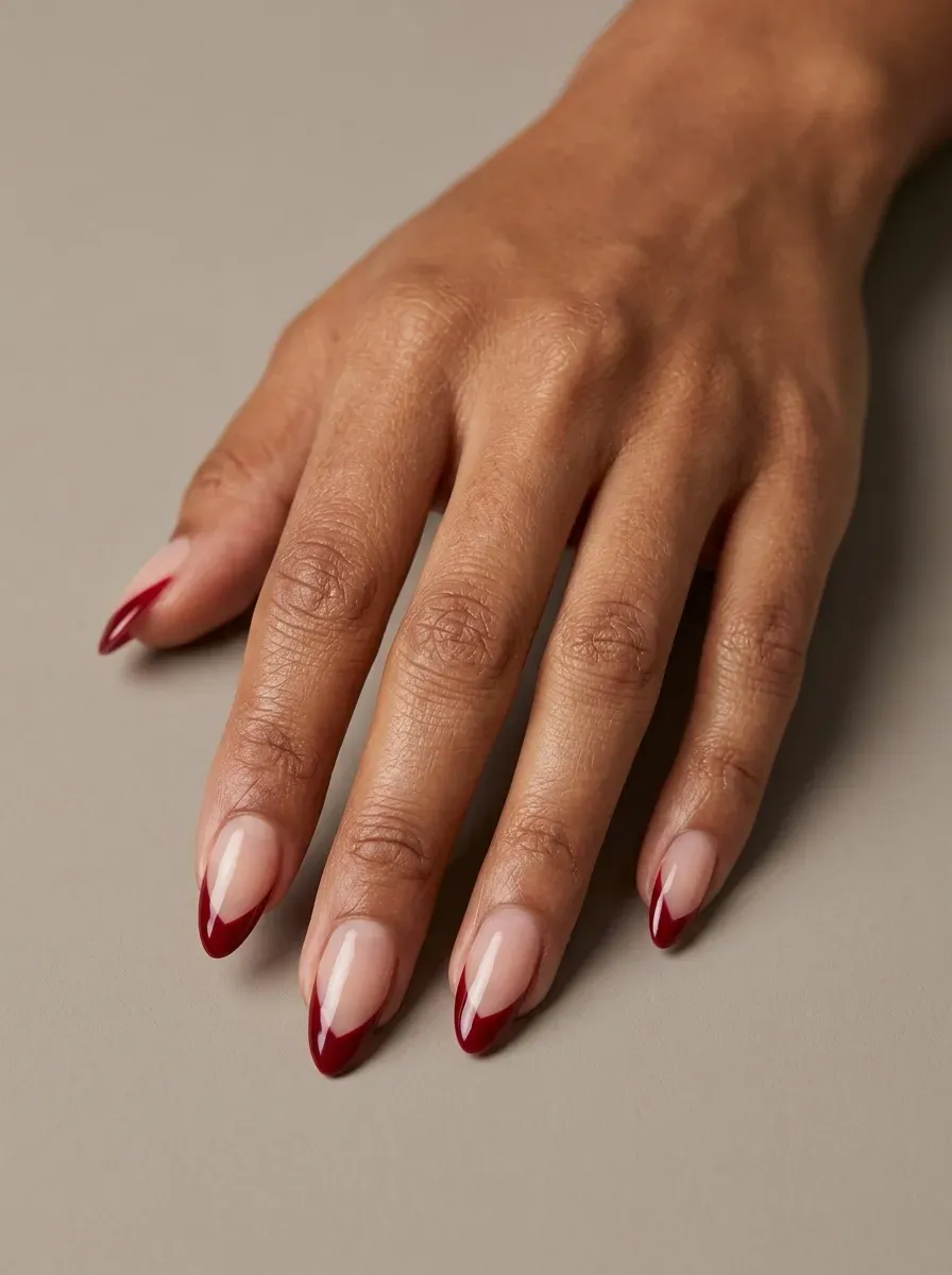 Sheer nude nails with black French tips and tiny eerie eye details