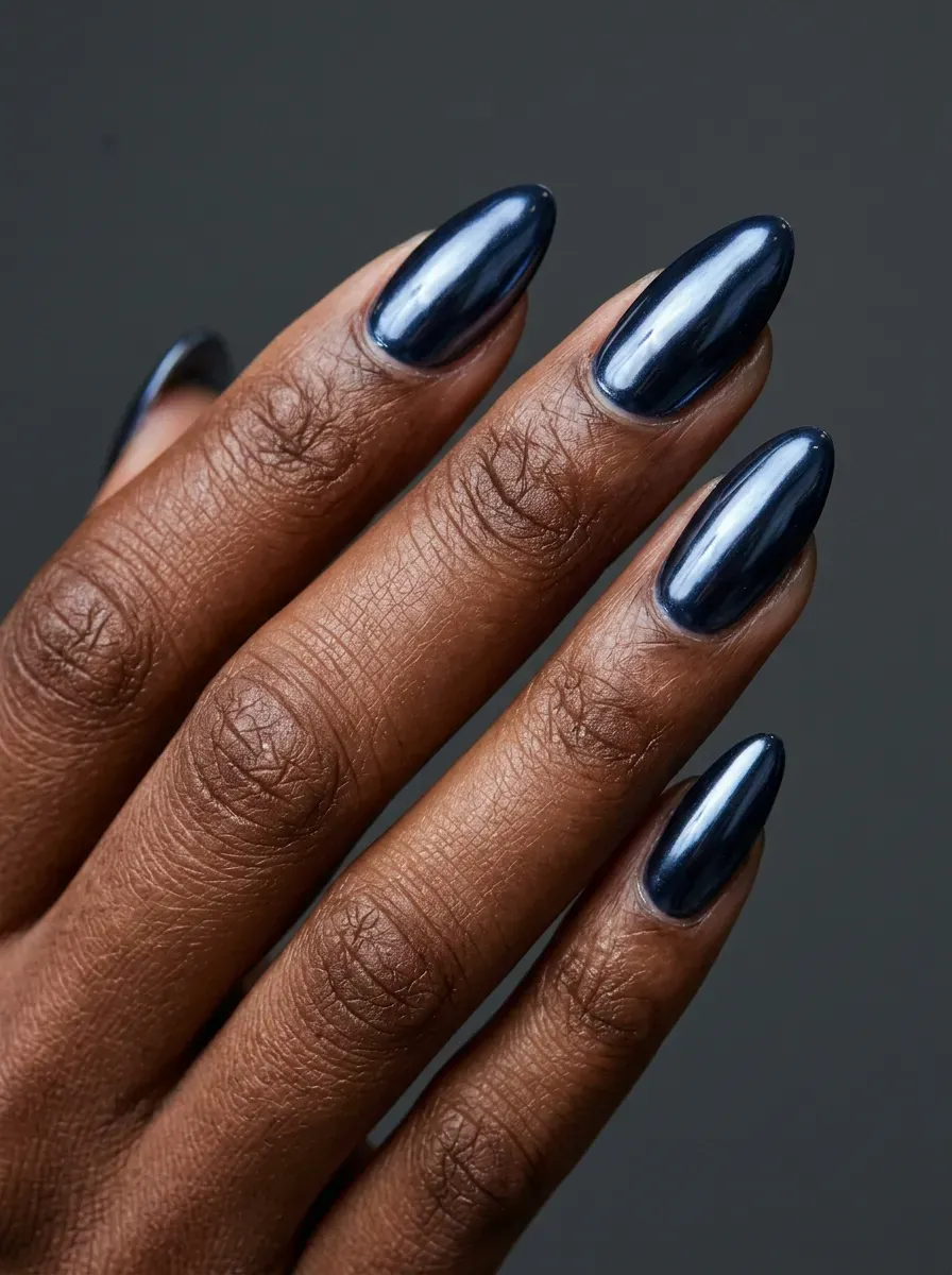 Deep midnight blue chrome nails with reflective supernatural finish