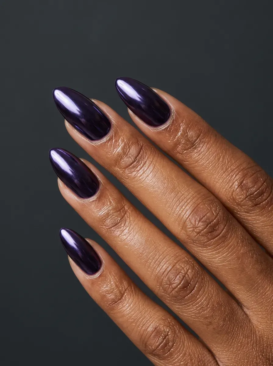 Dark purple chrome nails with reflective supernatural-inspired finish