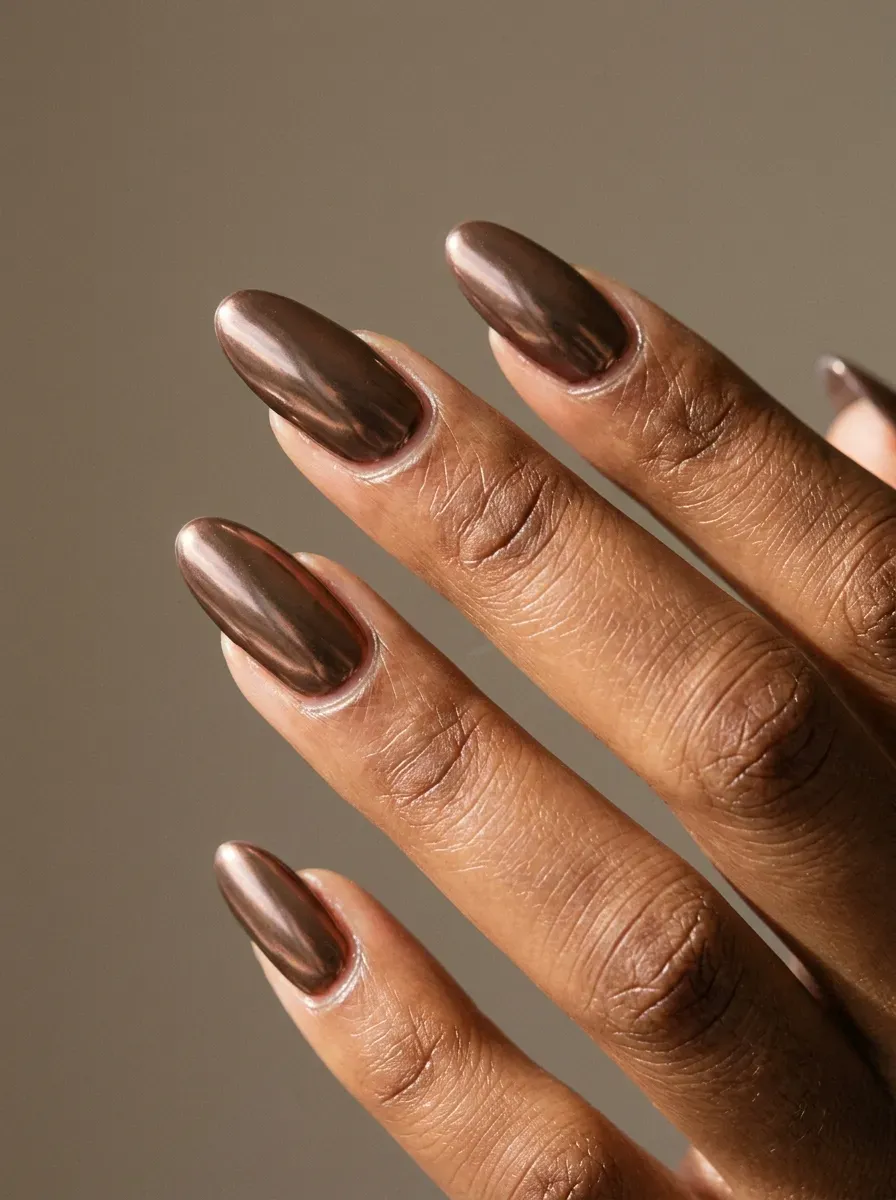 Long oval nails with reflective soft cocoa brown chrome finish