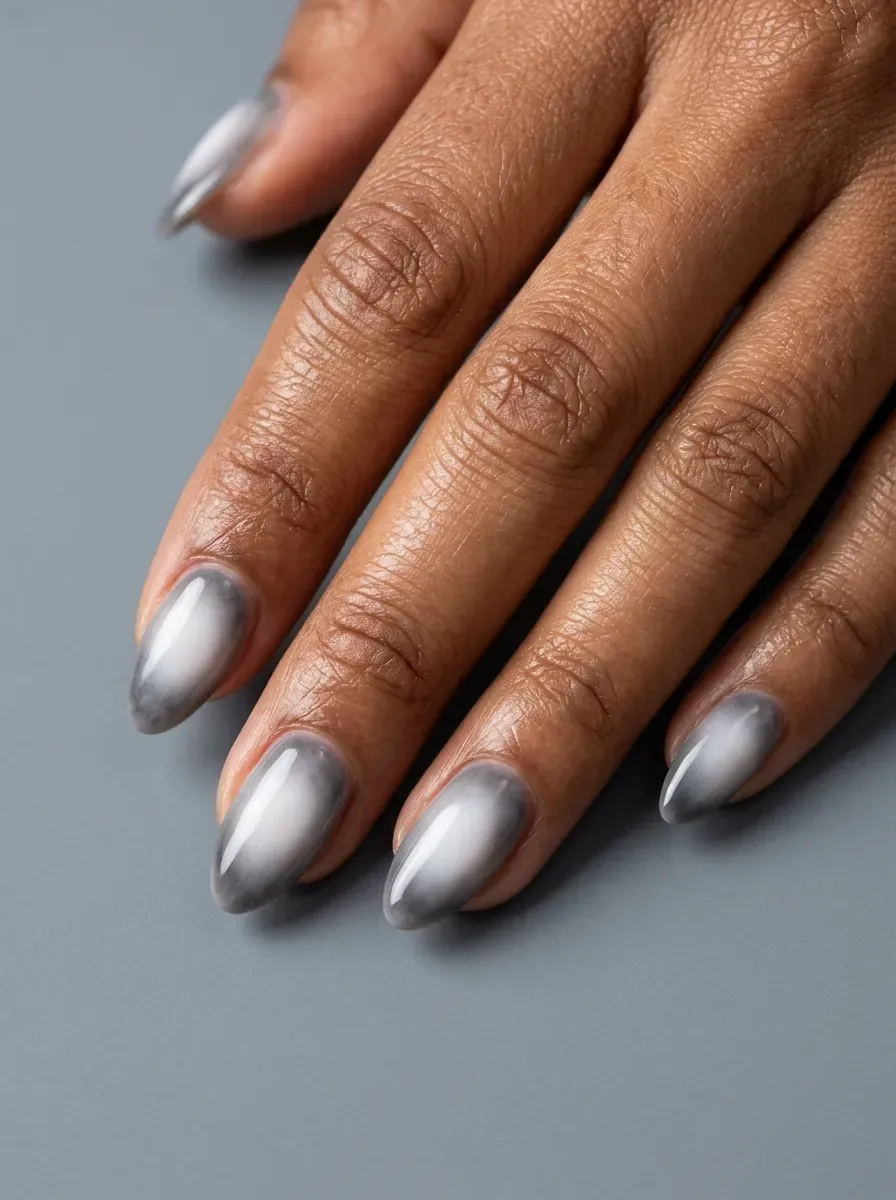 Smoky white aura nails fading through gray with glossy supernatural finish
